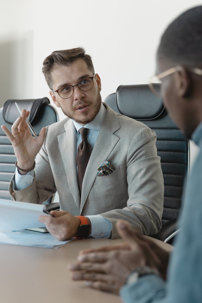 Two businessmen engaged in a professional meeting in a modern office setting.